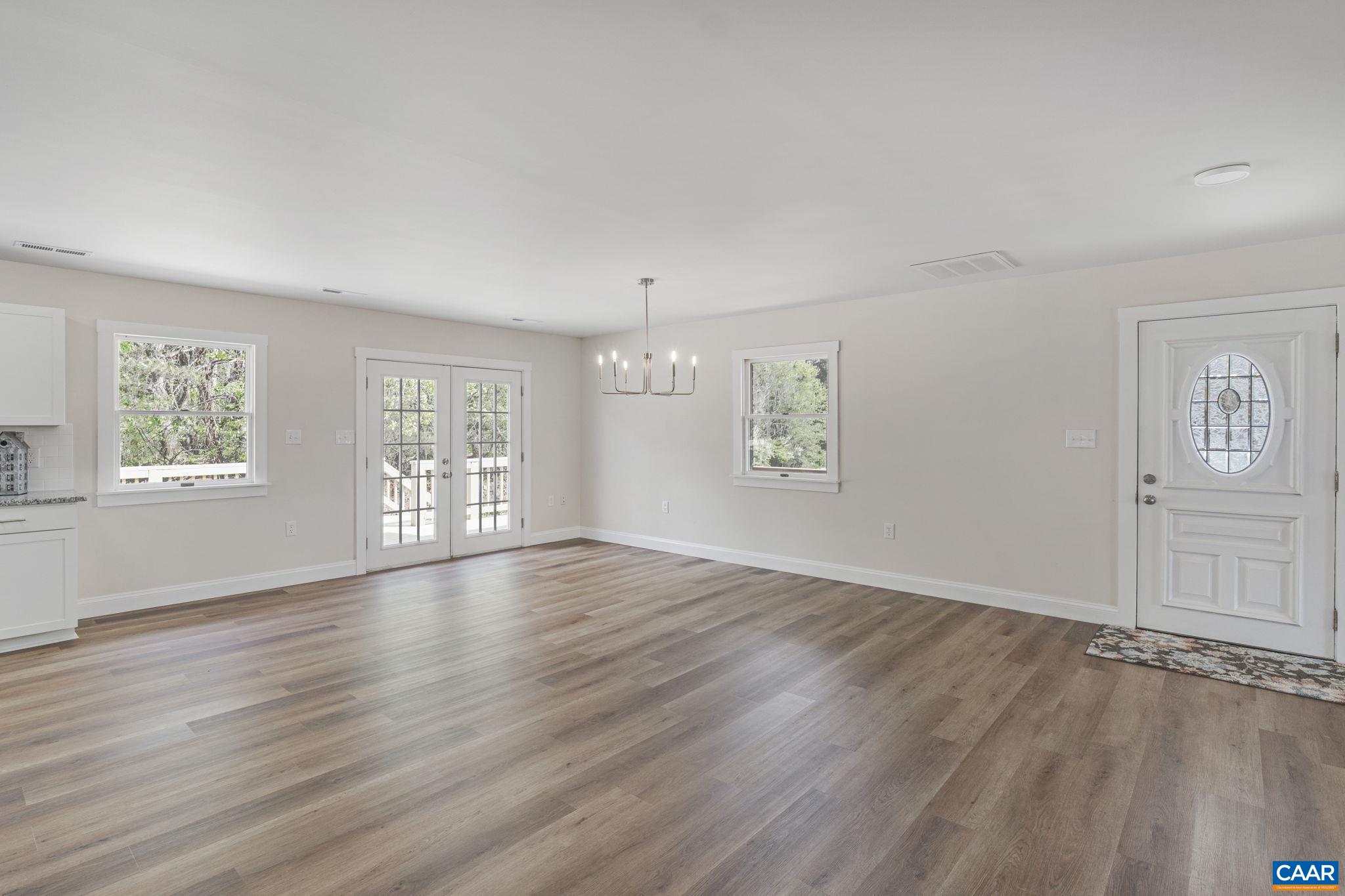 115 Montview Drive Ruckersville, VA 22968 - Photo 16 of 55 an empty room with wooden floor and windows
