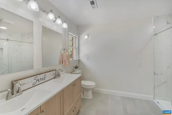 a bathroom with a sink a mirror and a toilet