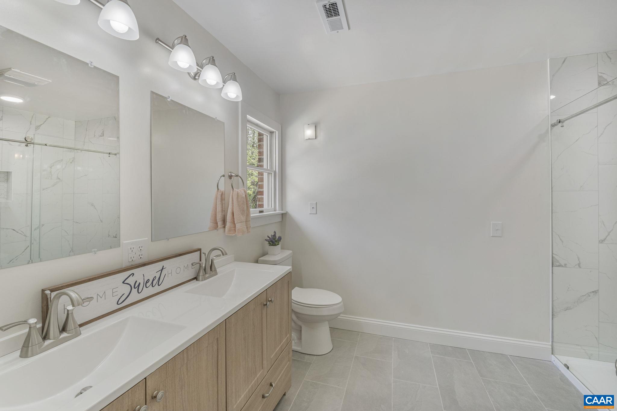 115 Montview Drive Ruckersville, VA 22968 - Photo 24 of 55 a bathroom with a sink a toilet and shower