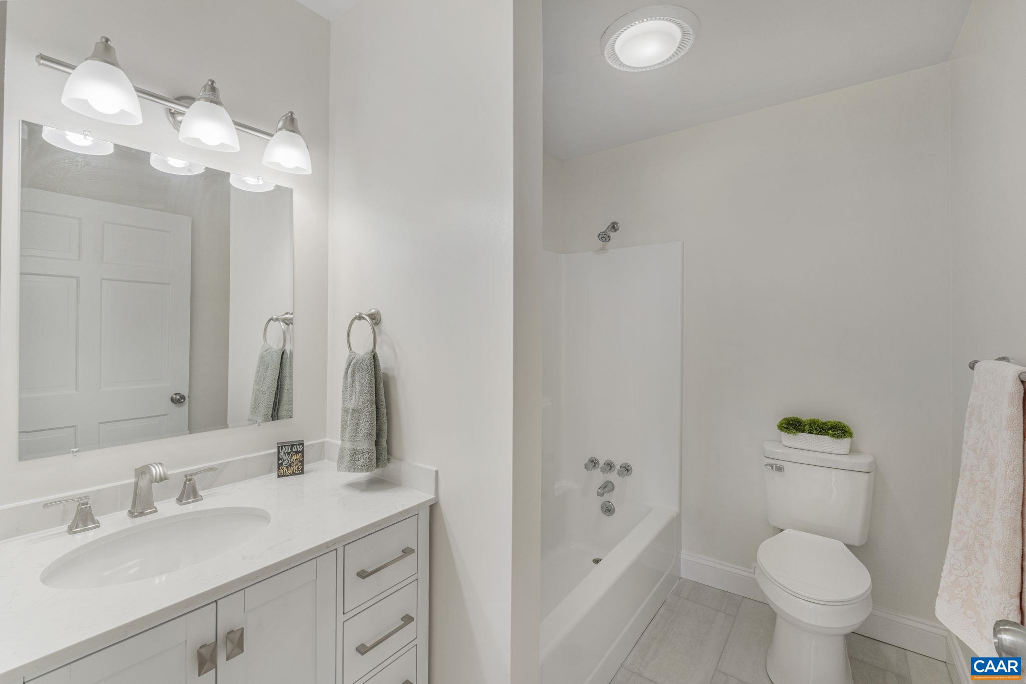 115 Montview Drive Ruckersville, VA 22968 - Photo 30 of 55 a bathroom with a granite countertop sink mirror vanity and toilet