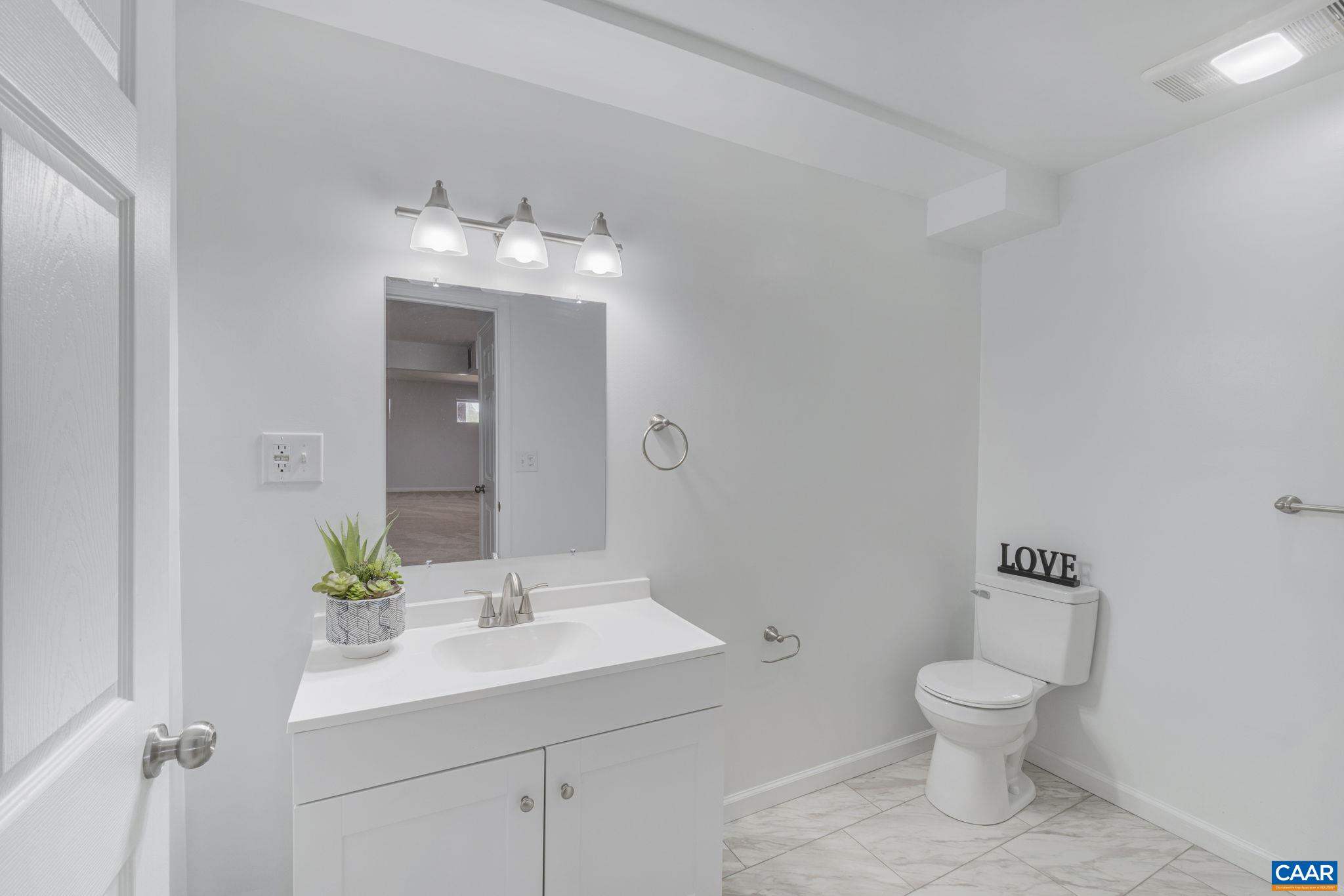 115 Montview Drive Ruckersville, VA 22968 - Photo 40 of 55 a bathroom with a toilet sink and mirror