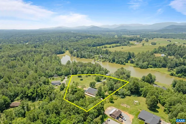 a view of a house with a yard and sitting area