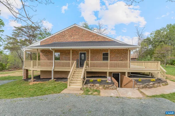 a large kitchen with stainless steel appliances granite countertop a sink dishwasher a stove with wooden cabinets and floors
