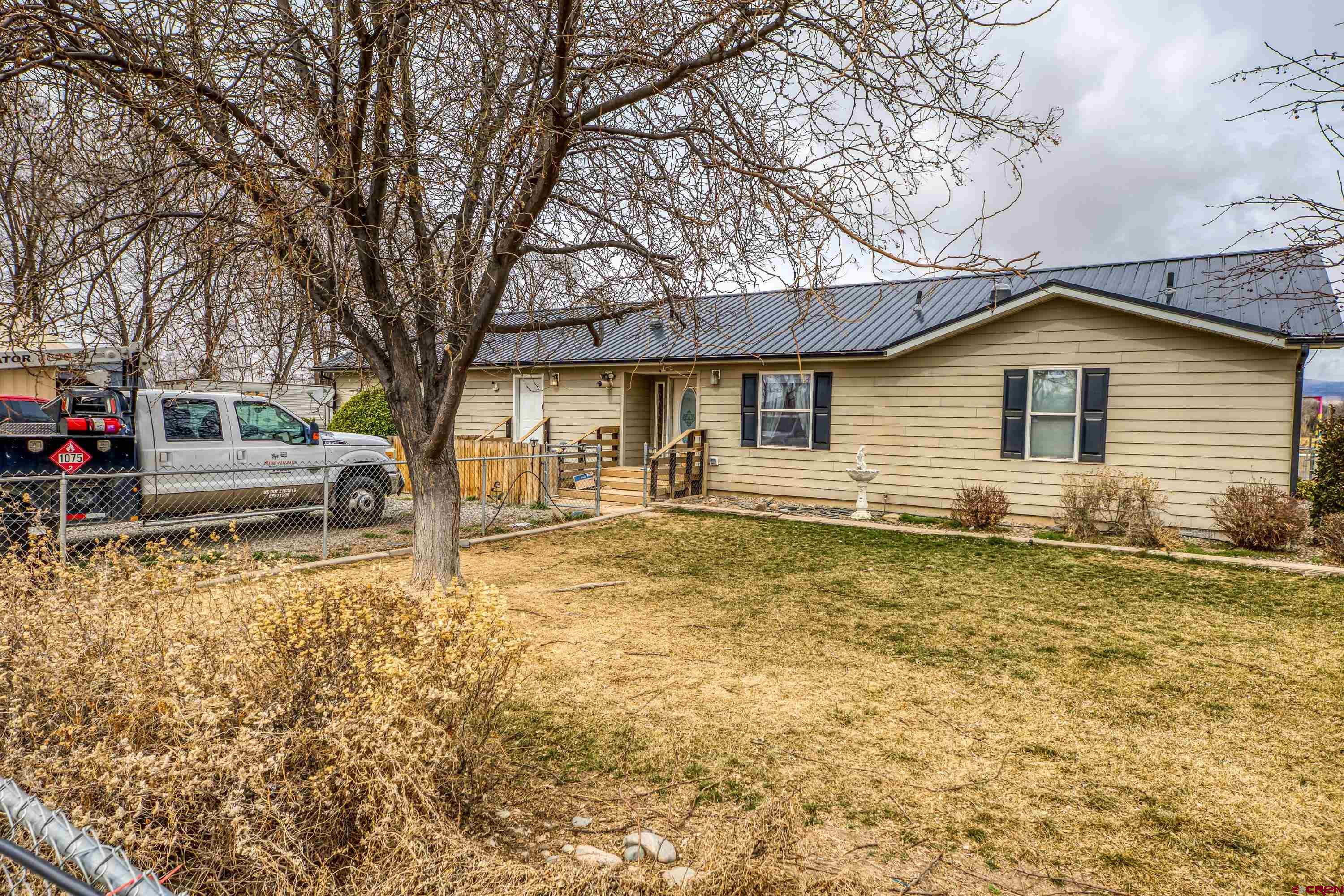a front view of a house with a yard covered with snow