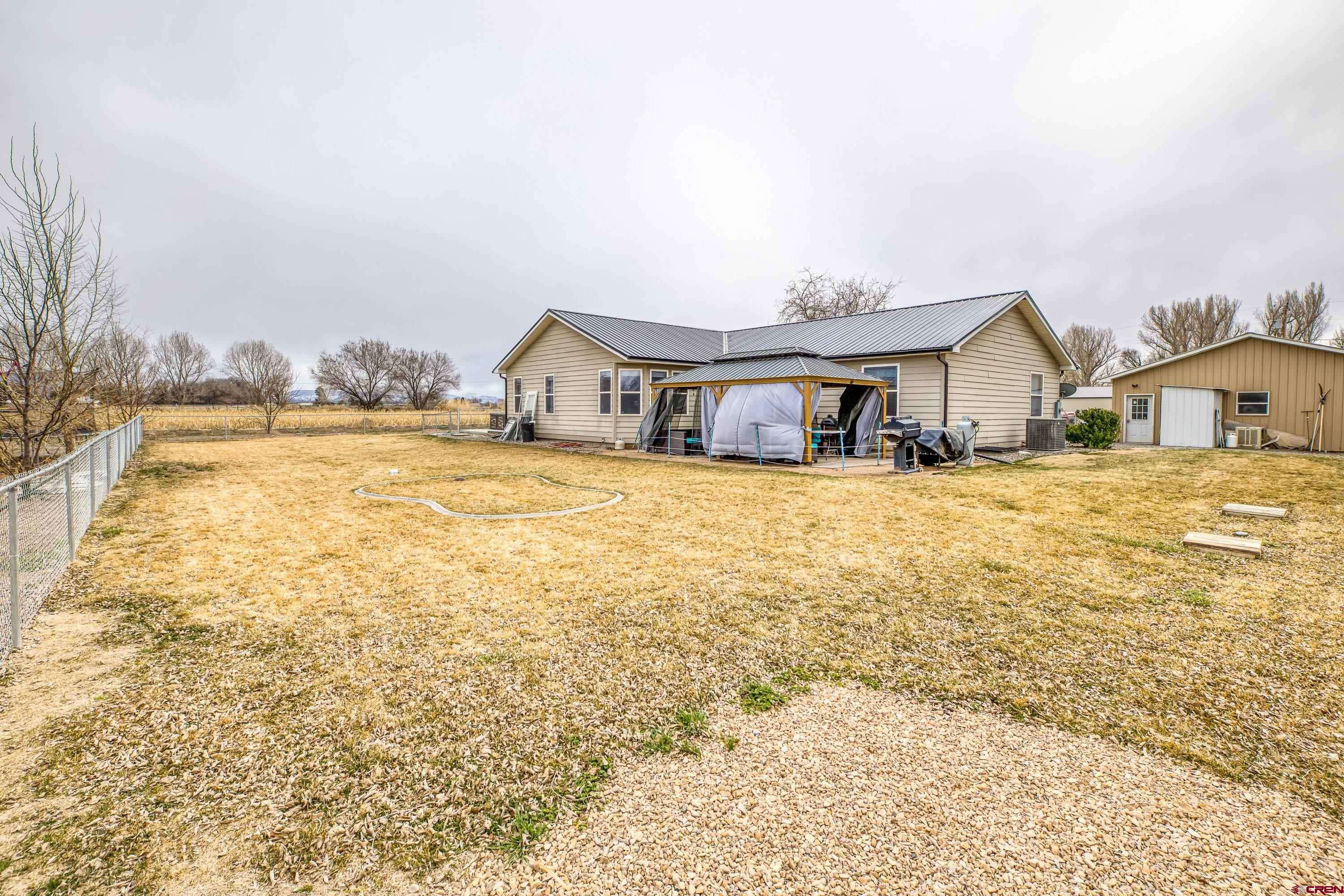 14473 Deer Run Road Delta, CO 81416 - Photo 12 of 26 a view of a house with a big yard and large trees
