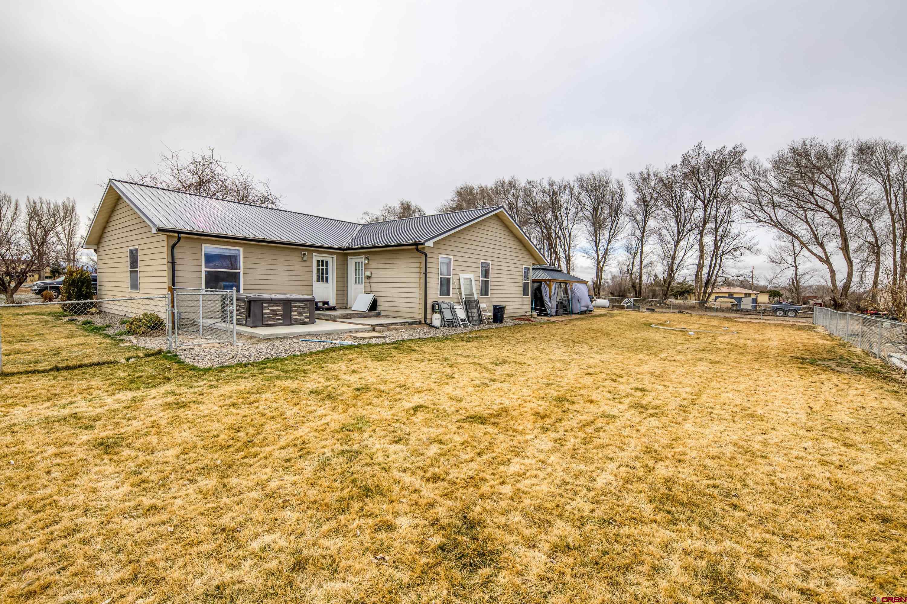 14473 Deer Run Road Delta, CO 81416 - Photo 13 of 26 a front view of house with yard and trees in the background