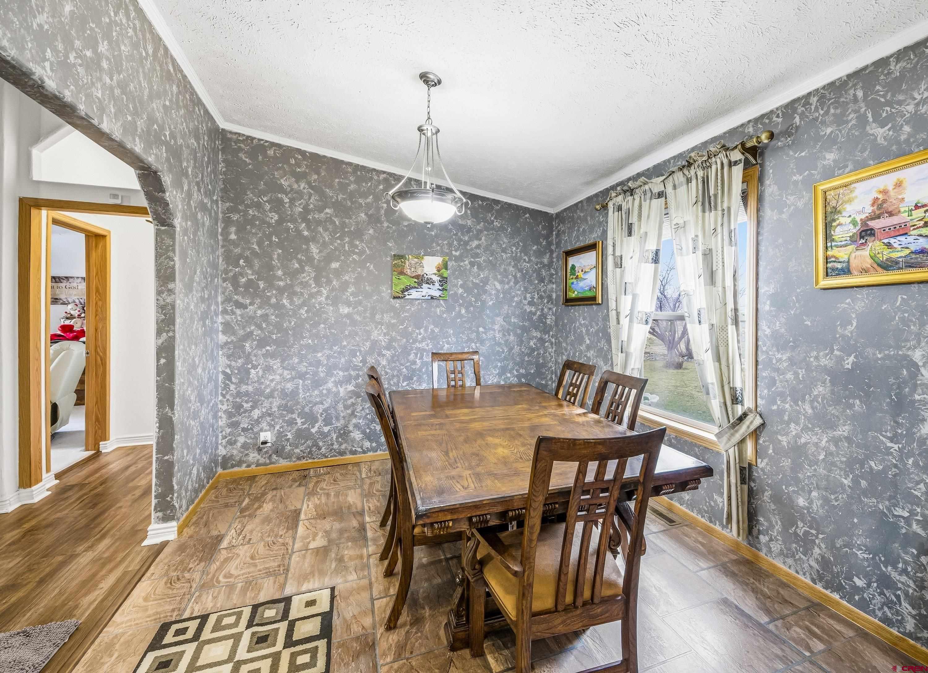 14473 Deer Run Road Delta, CO 81416 - Photo 2 of 26 a view of a dining room with furniture and wooden floor