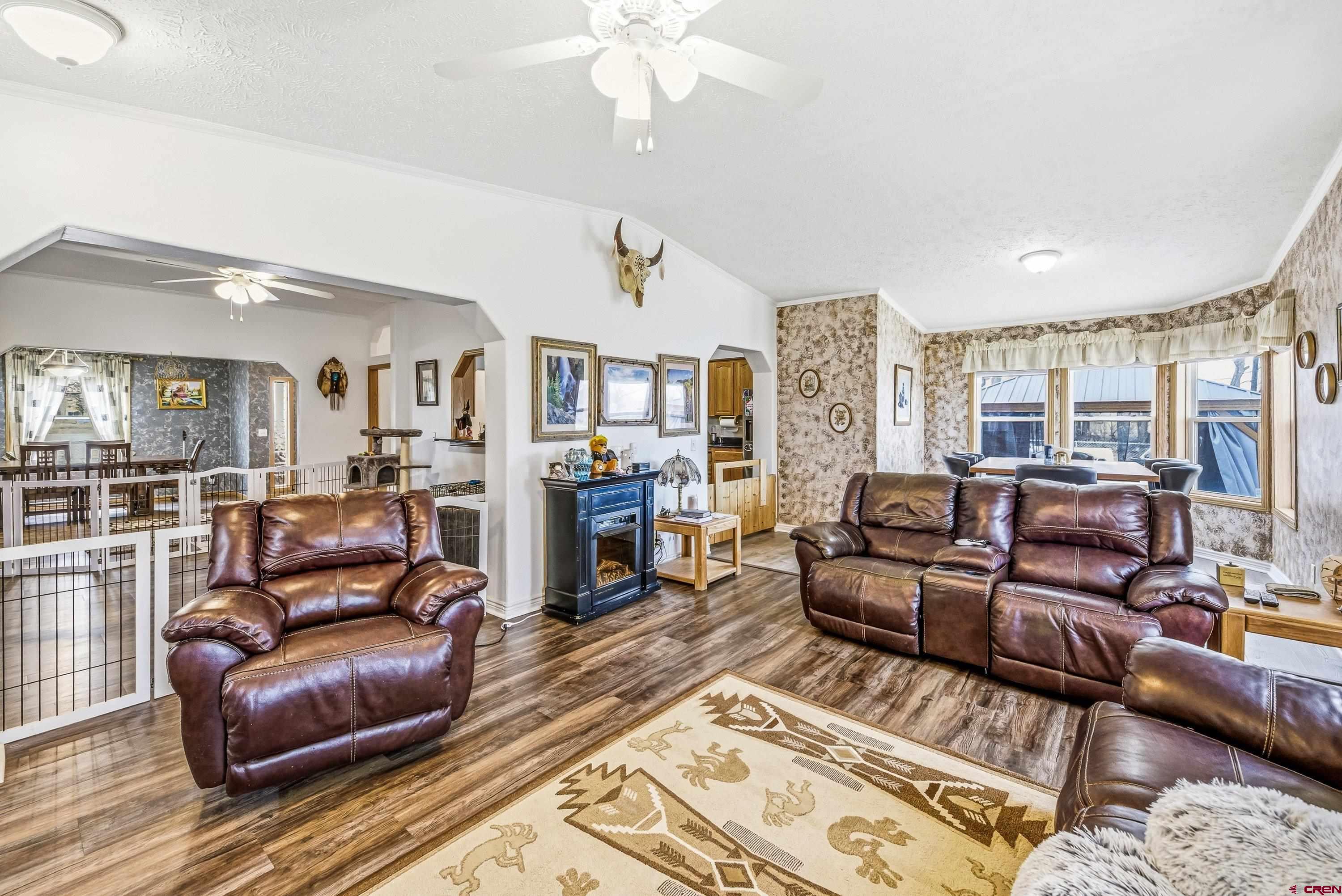 14473 Deer Run Road Delta, CO 81416 - Photo 7 of 26 a living room with furniture and a wooden floor