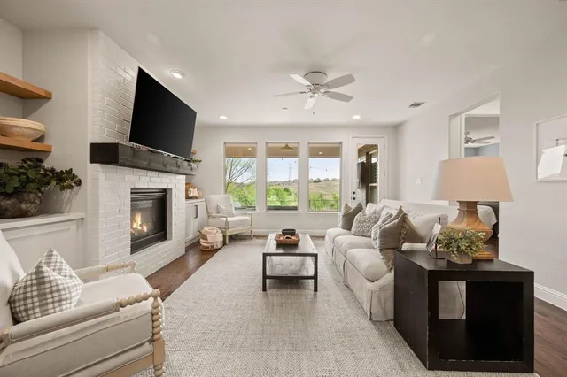 a living room with furniture a flat screen tv and a fireplace