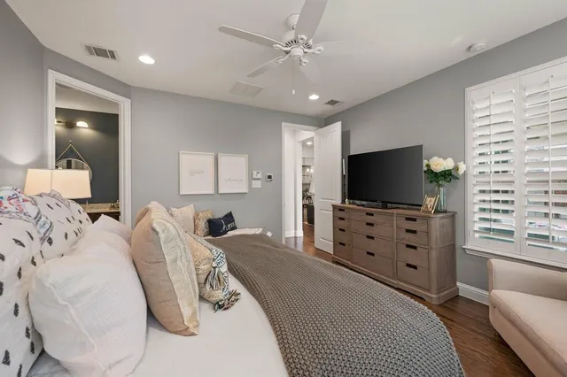 a bedroom with furniture and a flat screen tv
