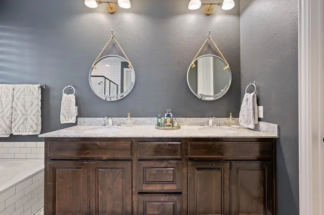 a bathroom with a double vanity sink and a mirror