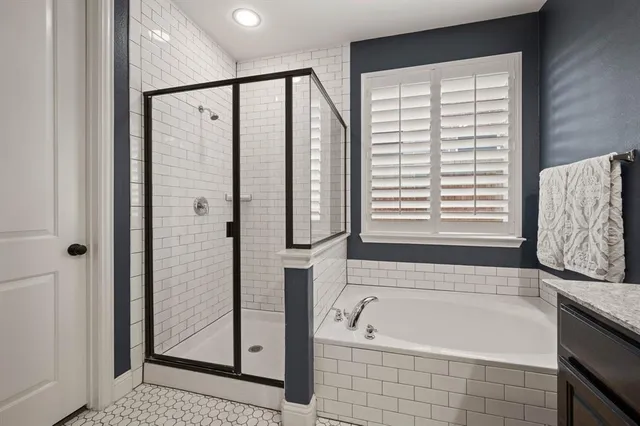 a bathroom with a bathtub a shower and a sink