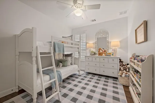 a room with a baby crib and a dresser