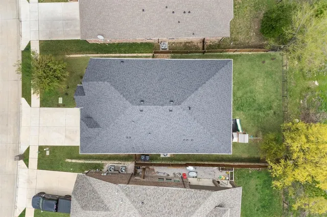 an aerial view of a house with a yard and lake view