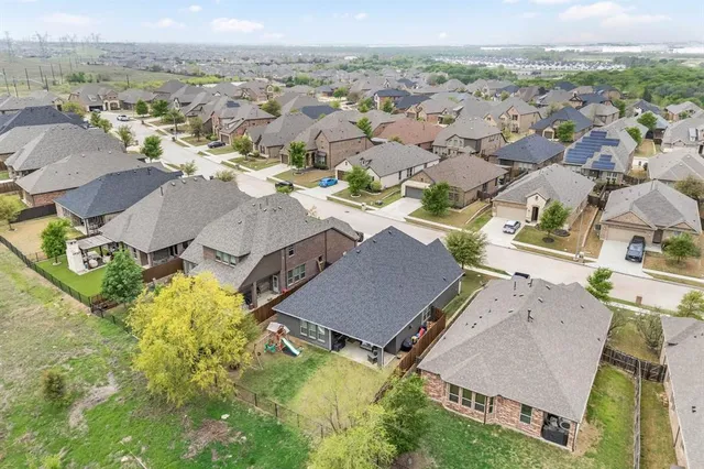 an aerial view of residential houses with outdoor space