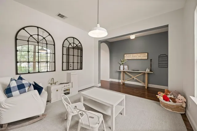 a living room with furniture a chandelier and a window