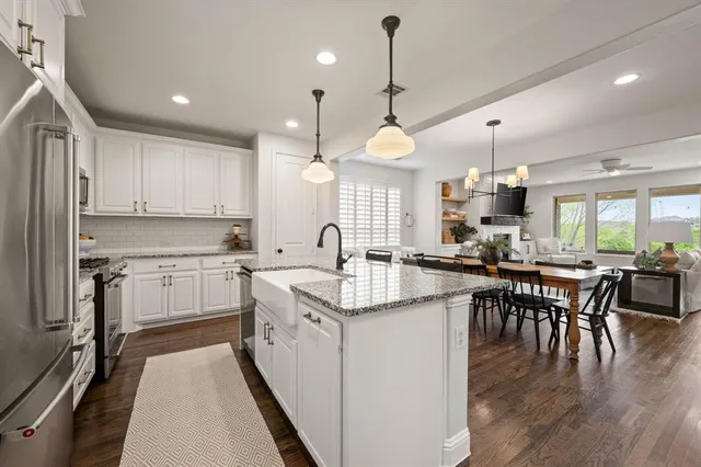 a kitchen with lots of counter space a sink appliances and dining table