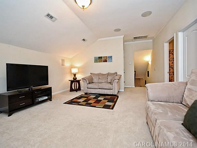 342 Miners Cove Way Fort Mill, SC 29708 - Photo 11 of 16 a living room with furniture and a flat screen tv