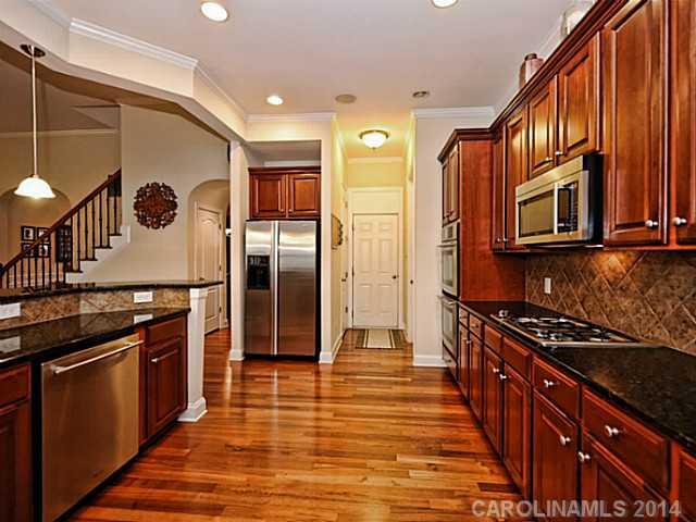 342 Miners Cove Way Fort Mill, SC 29708 - Photo 7 of 16 a kitchen with stainless steel appliances granite countertop a stove and a refrigerator