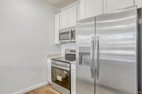 a kitchen with cabinets and stainless steel appliances