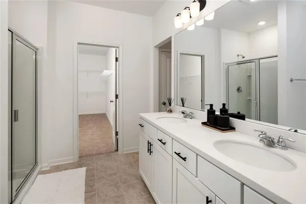 a bathroom with a double vanity sink mirror and shower