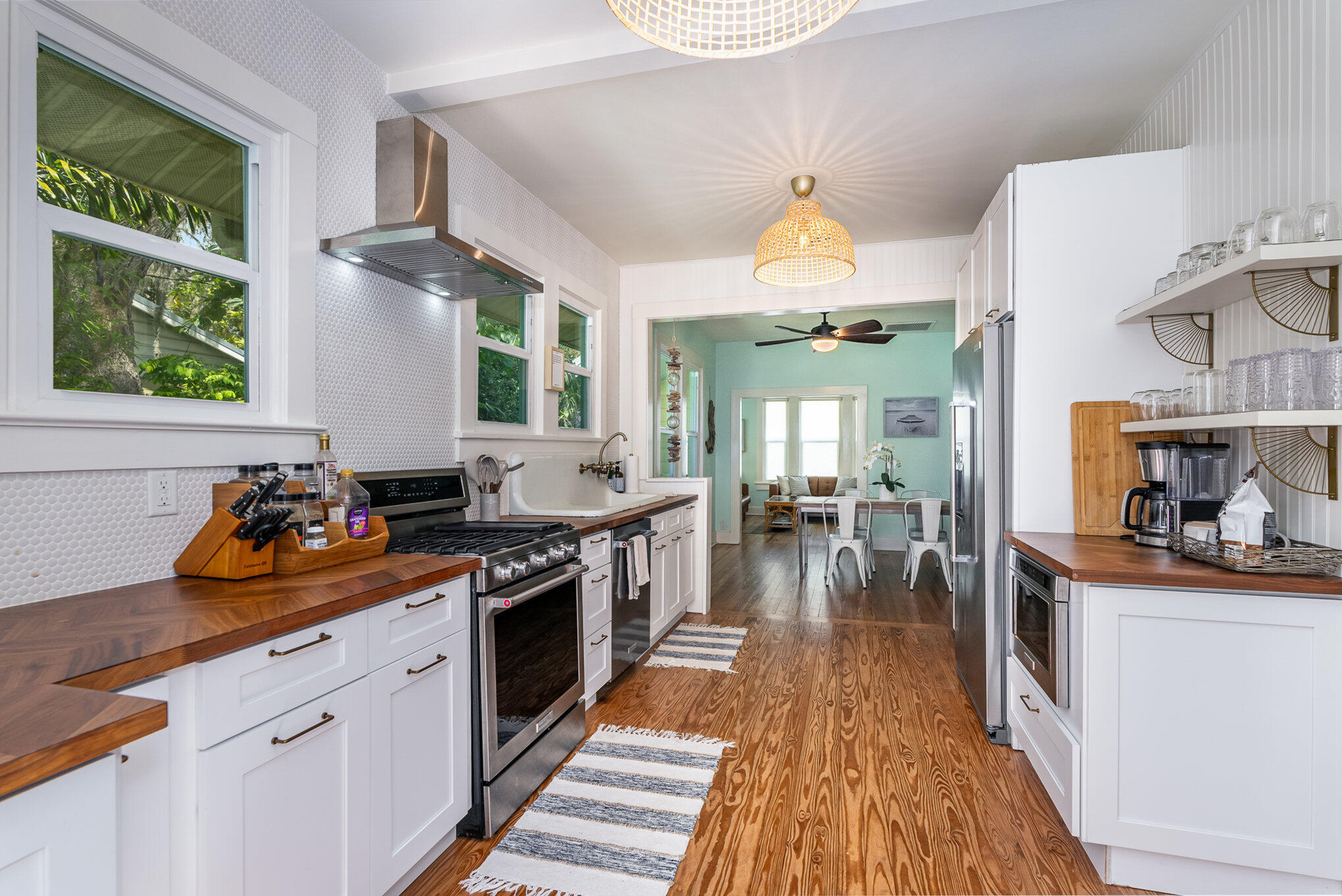 703 Shady Lane Melbourne, FL 32935 - Photo 12 of 23 a kitchen with stove a sink and cabinets