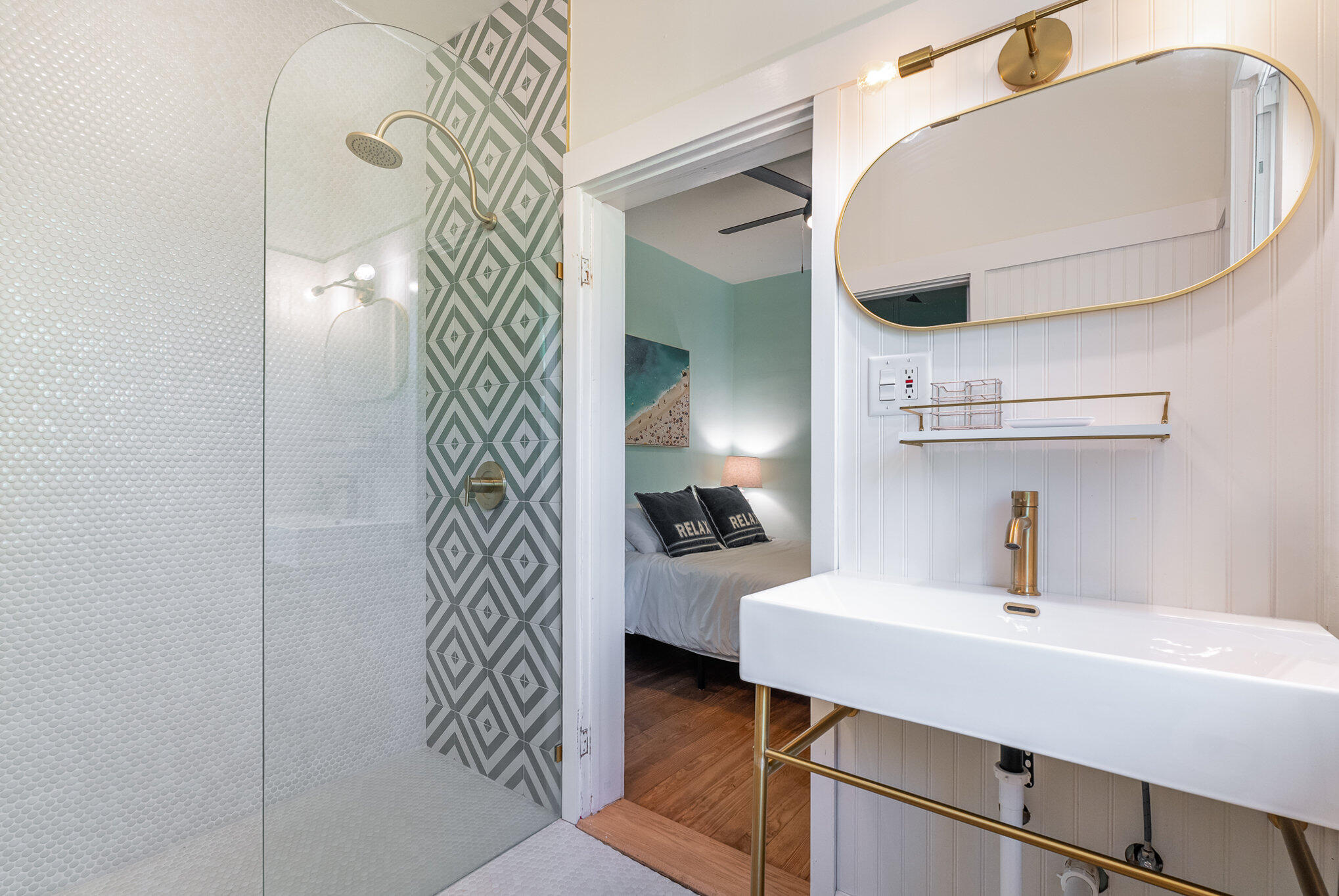 703 Shady Lane Melbourne, FL 32935 - Photo 16 of 23 a bathroom with a sink a mirror and vanity