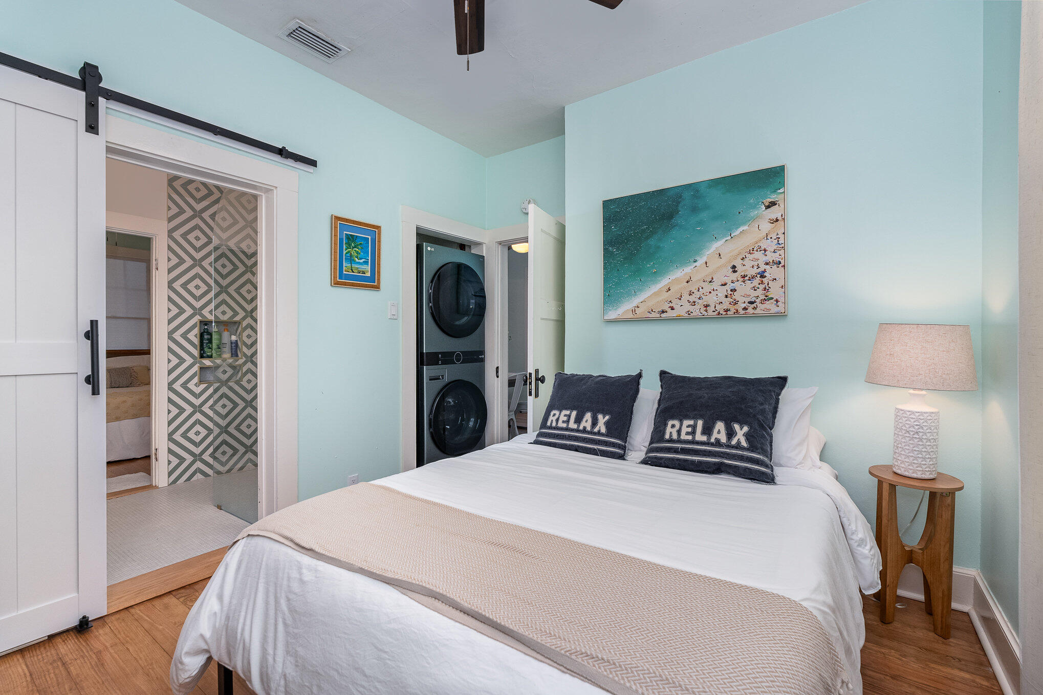 703 Shady Lane Melbourne, FL 32935 - Photo 17 of 23 a bedroom with a bed and a lamp on table