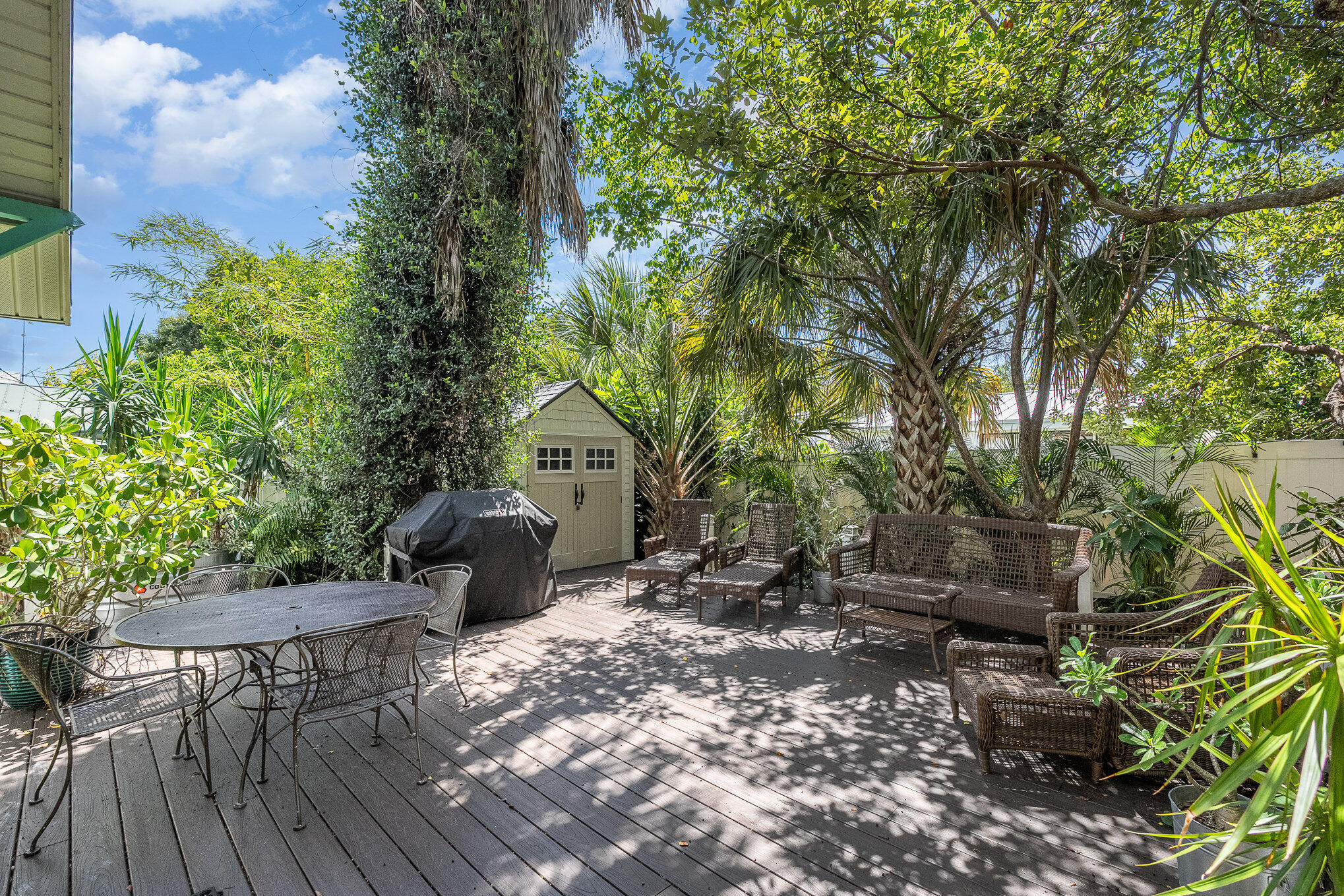 703 Shady Lane Melbourne, FL 32935 - Photo 22 of 23 a backyard of a house with table and chairs