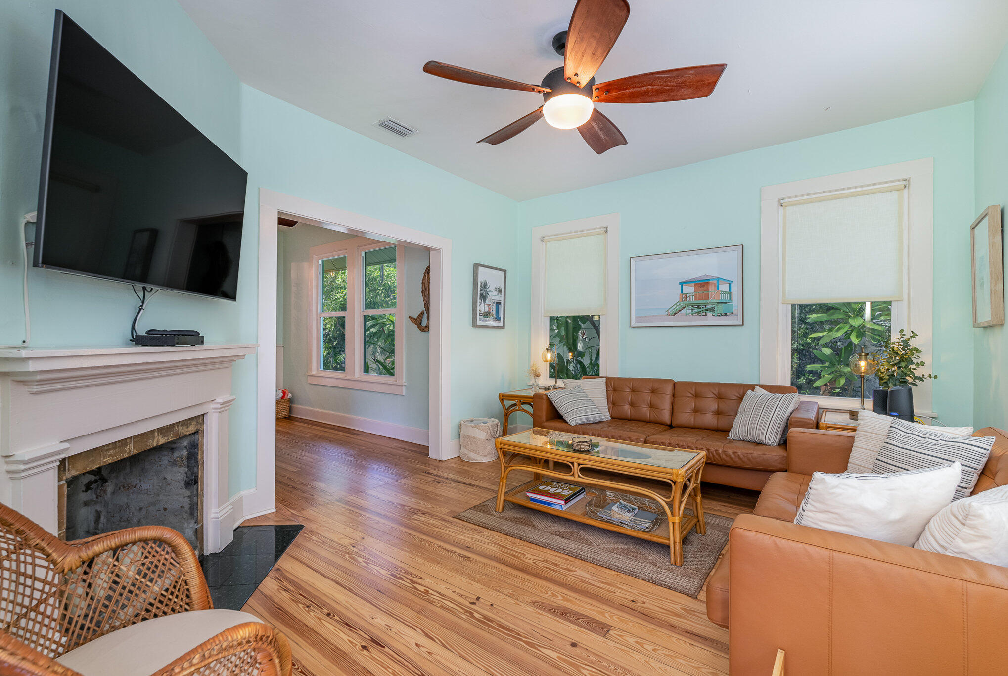 703 Shady Lane Melbourne, FL 32935 - Photo 6 of 23 a living room with furniture a flat screen tv and a fireplace