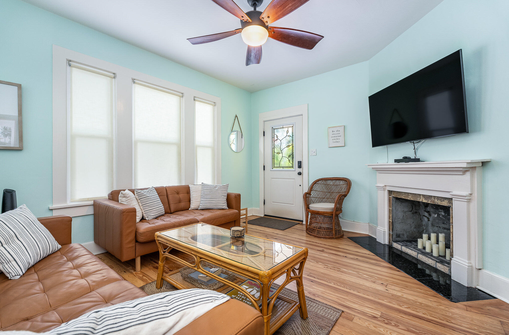 703 Shady Lane Melbourne, FL 32935 - Photo 7 of 23 a living room with furniture a fireplace and a flat screen tv