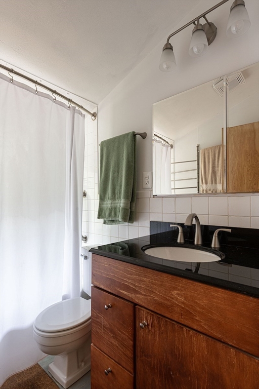 31 Turning Mill Road Lexington, MA 02420 - Photo 32 of 32 a bathroom with a granite countertop sink and a mirror
