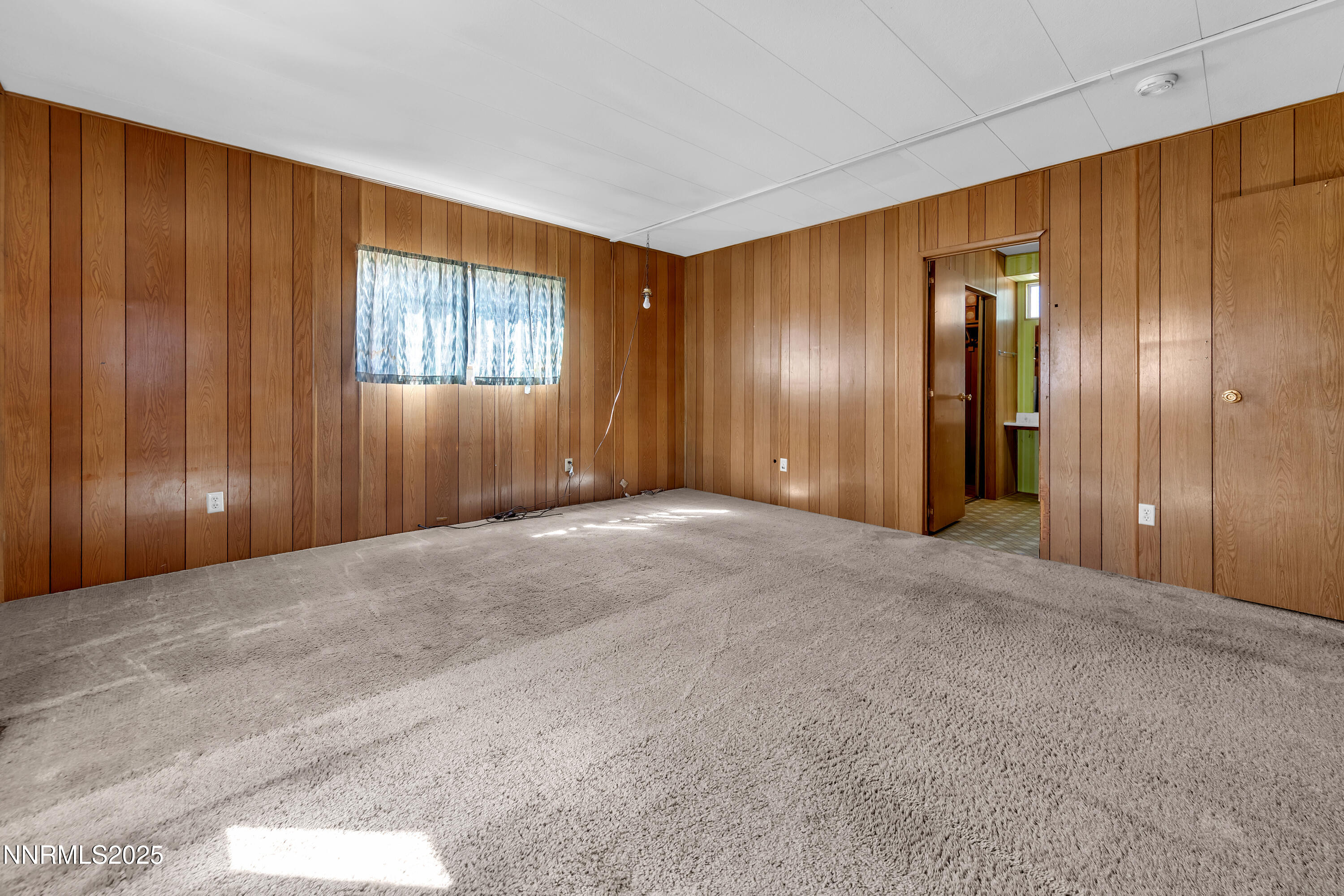 5961 Spring Valley Circle Sun Valley, NV 89433 - Photo 11 of 20 a view of an empty room with wooden walls