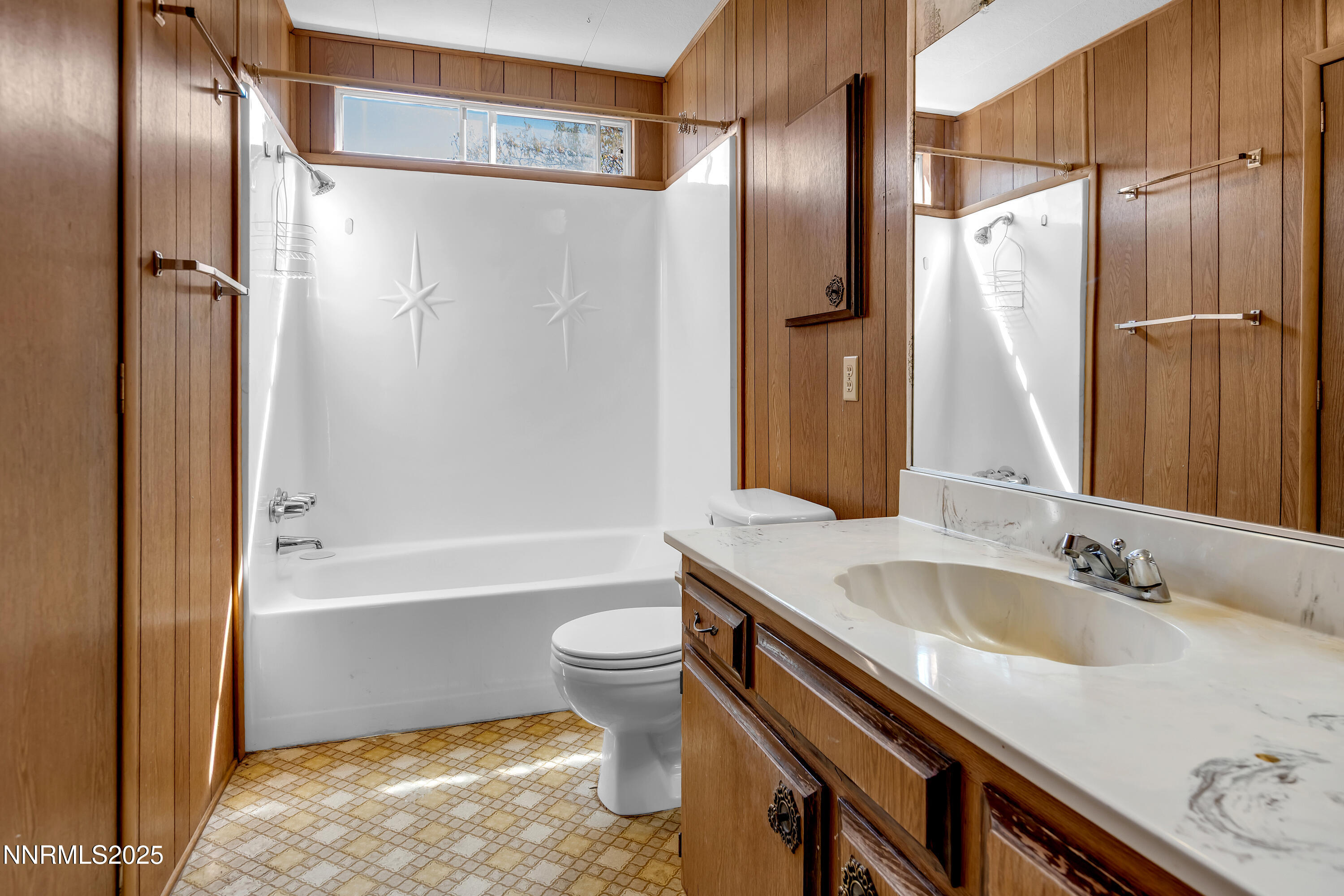 5961 Spring Valley Circle Sun Valley, NV 89433 - Photo 12 of 20 a bathroom with a sink and a large mirror