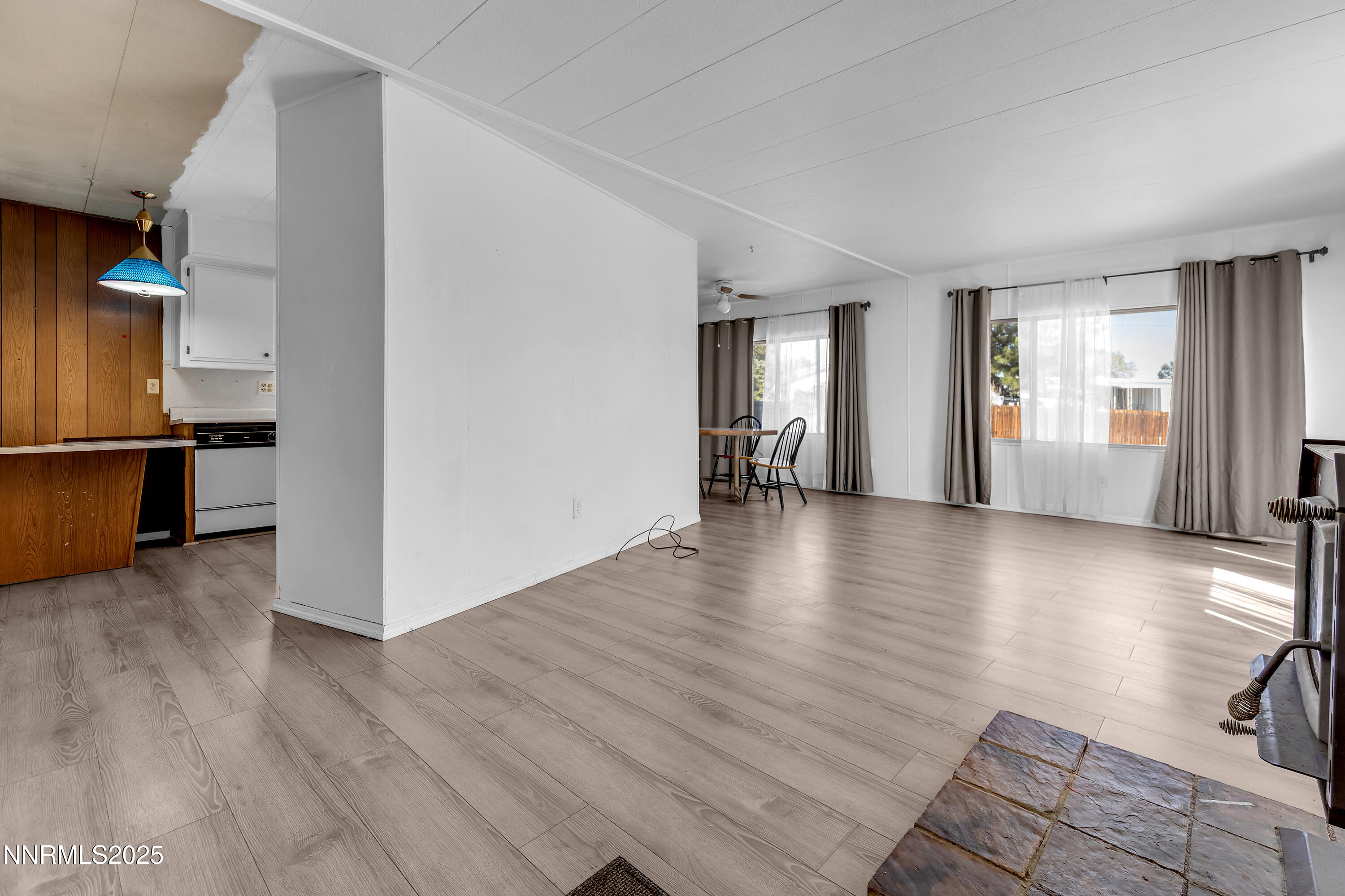 5961 Spring Valley Circle Sun Valley, NV 89433 - Photo 2 of 20 an empty room with wooden floor and windows