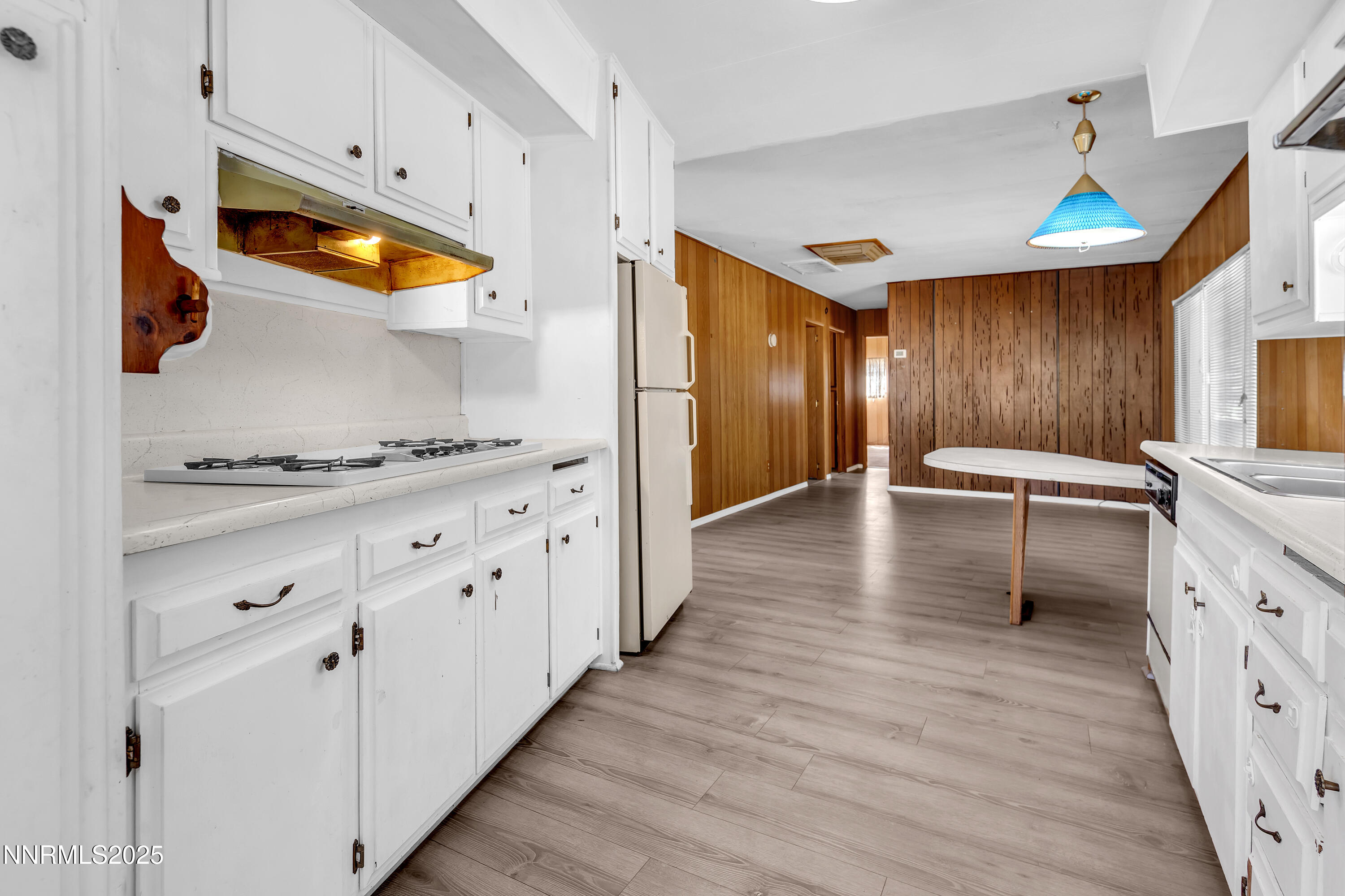 5961 Spring Valley Circle Sun Valley, NV 89433 - Photo 5 of 20 a kitchen with stainless steel appliances a stove a sink and a refrigerator