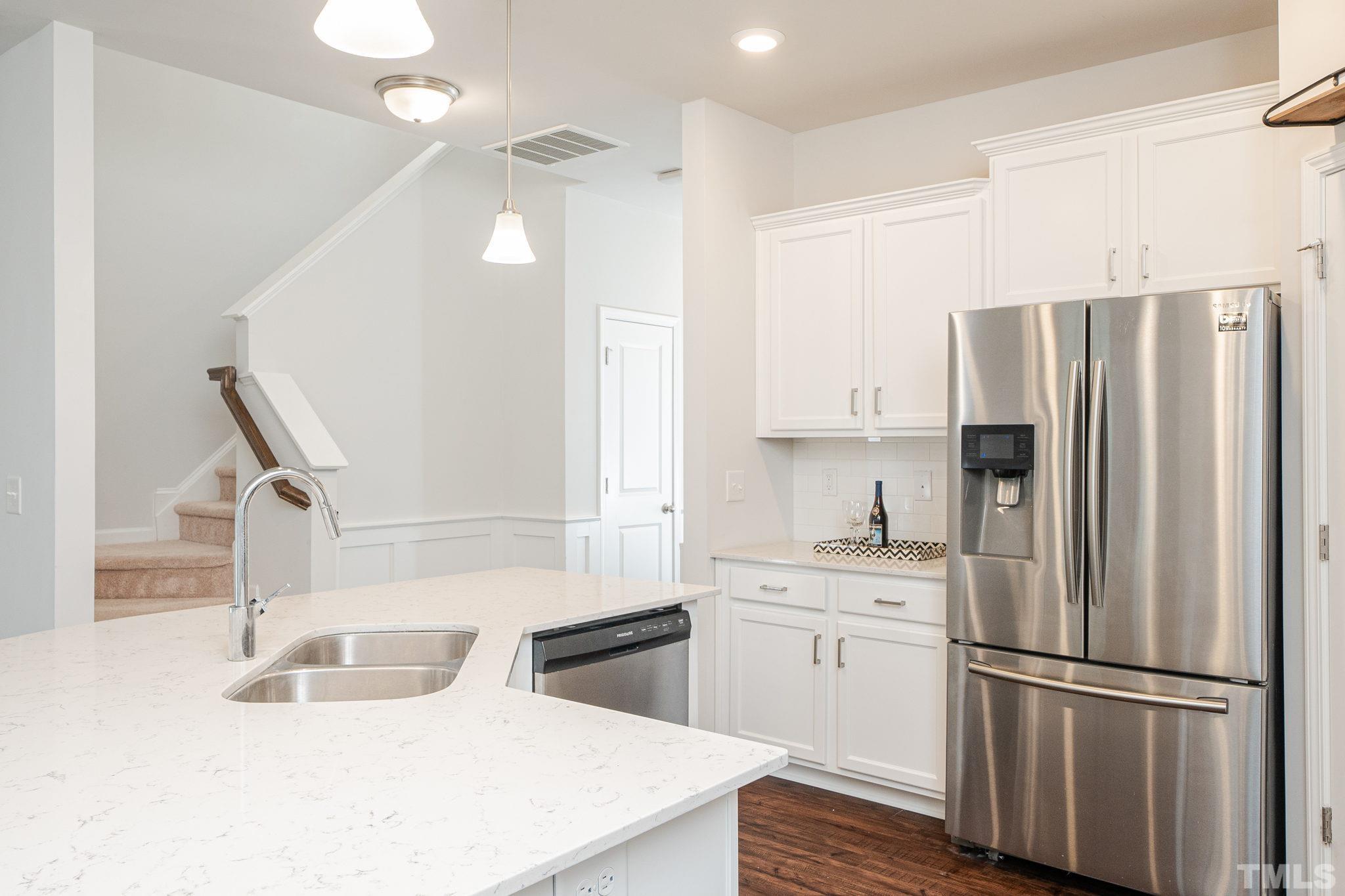 6075 Beale Loop Raleigh, NC 27616 - Photo 4 of 23 a kitchen with stainless steel appliances a refrigerator sink and cabinets
