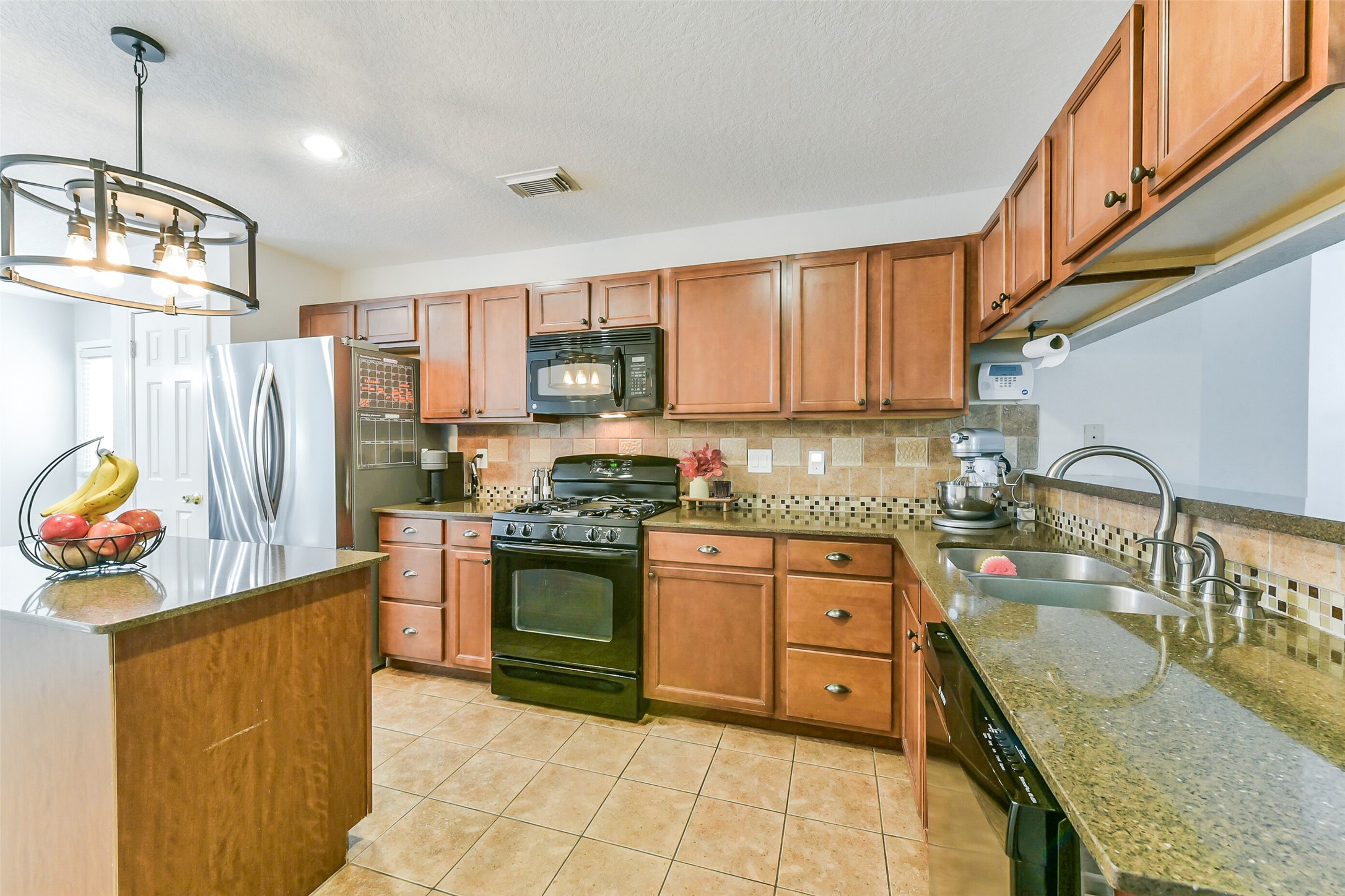 4010 Spring Branch Drive West Pearland, TX 77584 - Photo 11 of 35 a kitchen with stainless steel appliances granite countertop a sink stove and refrigerator