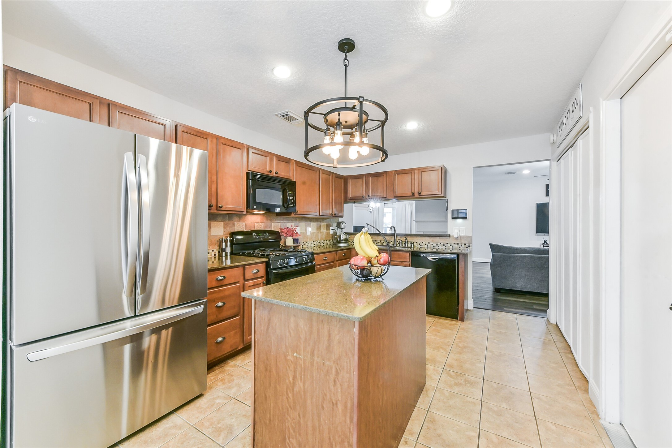 4010 Spring Branch Drive West Pearland, TX 77584 - Photo 12 of 35 a kitchen with stainless steel appliances granite countertop a refrigerator a stove a sink dishwasher a oven with a dining table and chairs