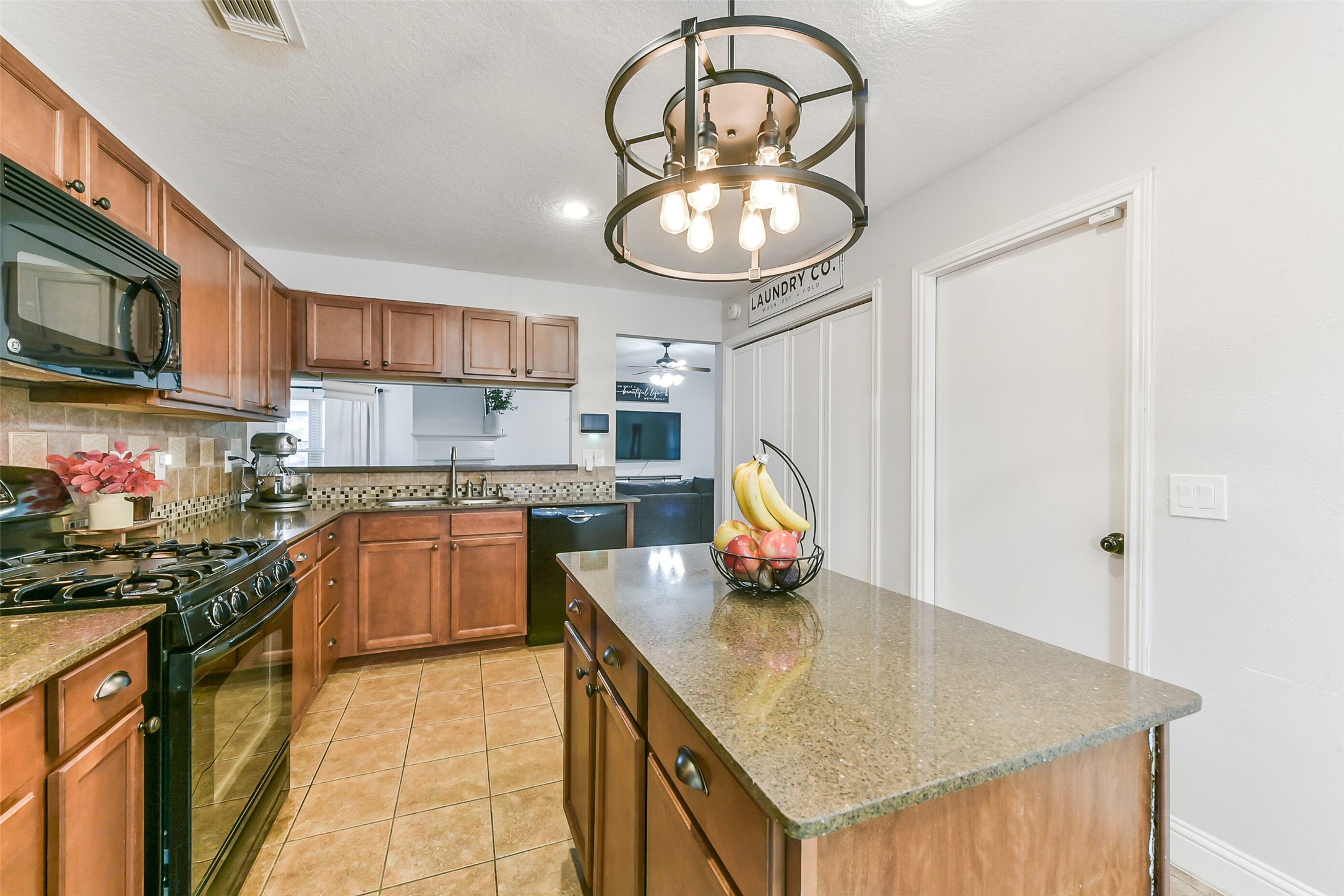 4010 Spring Branch Drive West Pearland, TX 77584 - Photo 13 of 35 a kitchen with stainless steel appliances granite countertop a sink dishwasher and cabinets with wooden floor