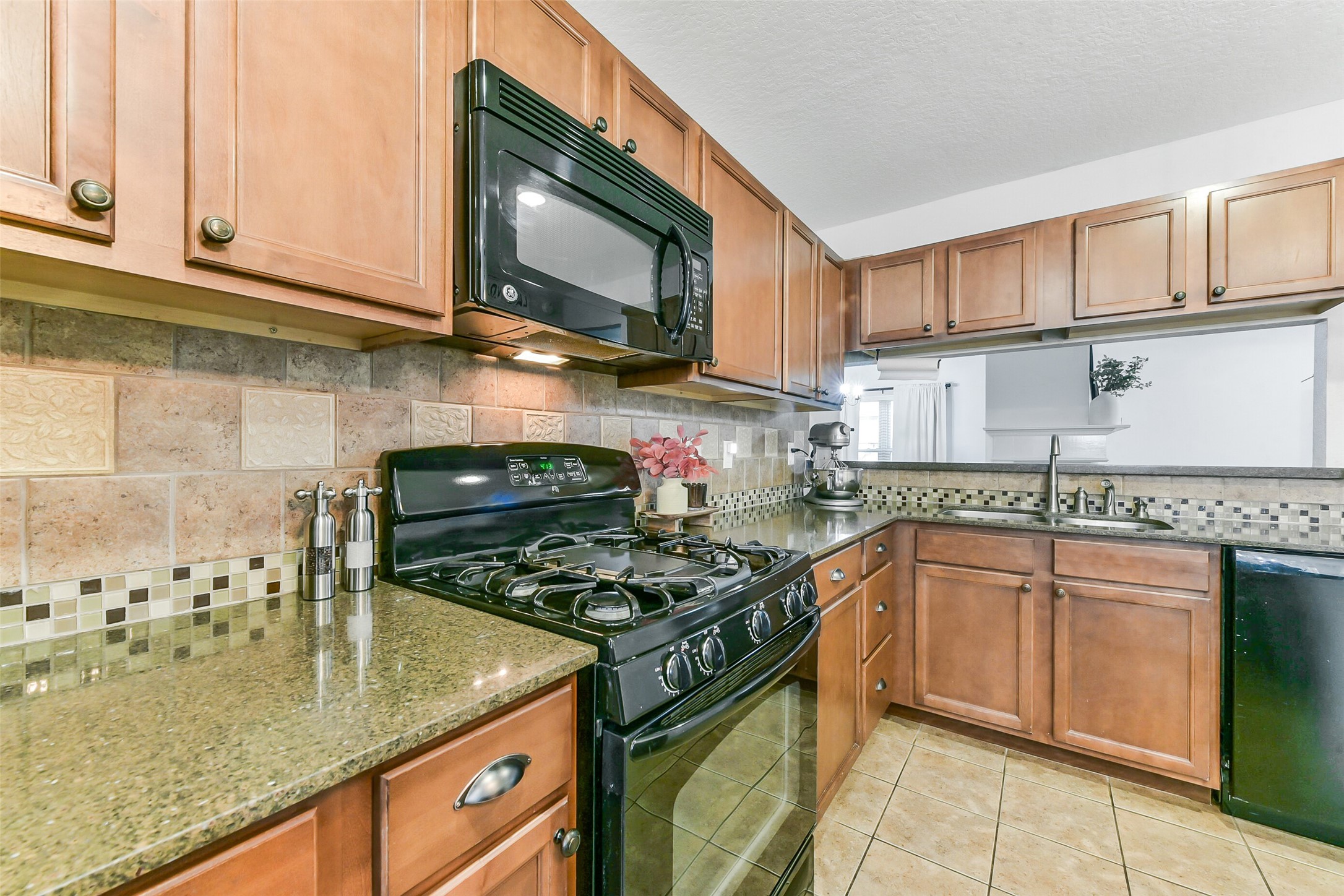 4010 Spring Branch Drive West Pearland, TX 77584 - Photo 15 of 35 a kitchen with stainless steel appliances granite countertop a sink stove and cabinets