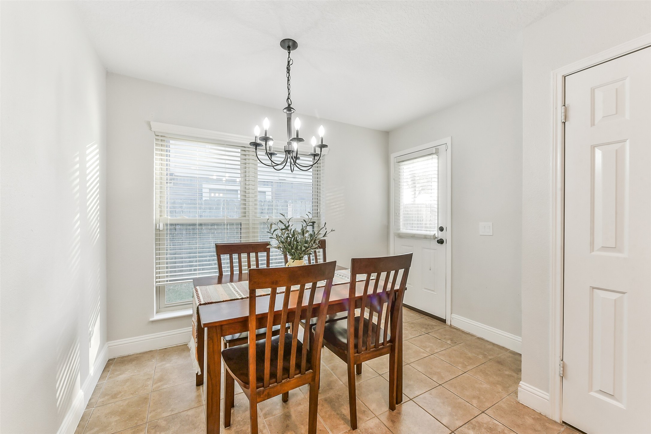 4010 Spring Branch Drive West Pearland, TX 77584 - Photo 16 of 35 a view of a dining room with furniture and chandelier