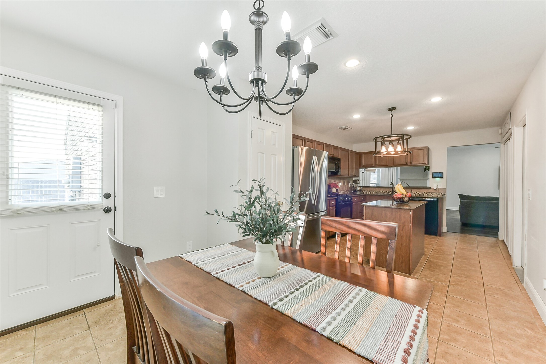 4010 Spring Branch Drive West Pearland, TX 77584 - Photo 17 of 35 a view of a dining room and livingroom with furniture wooden floor