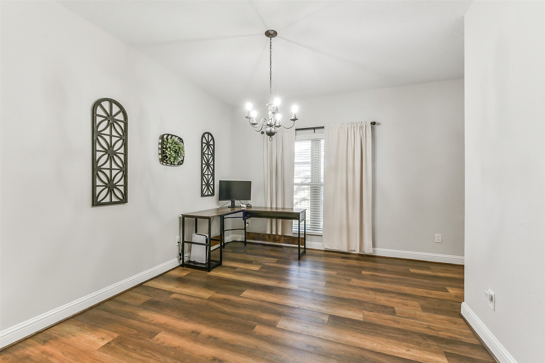 4010 Spring Branch Drive West Pearland, TX 77584 - Photo 18 of 35 a view of a livingroom with a furniture wooden floor and a chandelier
