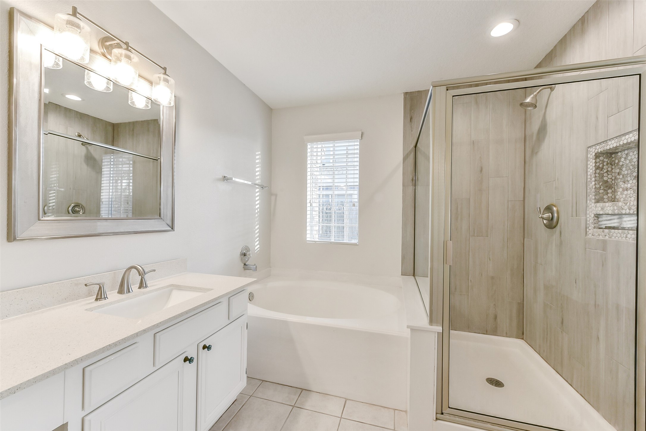 4010 Spring Branch Drive West Pearland, TX 77584 - Photo 25 of 35 a bathroom with a bathtub shower and a sink