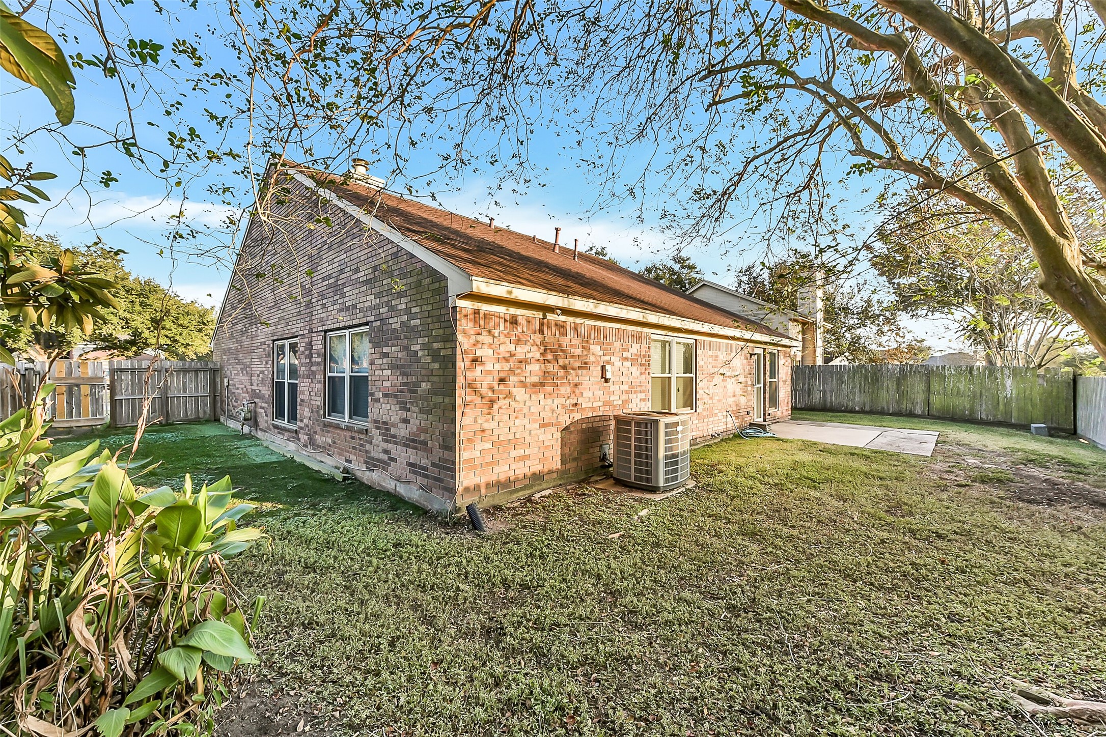 4010 Spring Branch Drive West Pearland, TX 77584 - Photo 33 of 35 a view of a house with backyard and a tree
