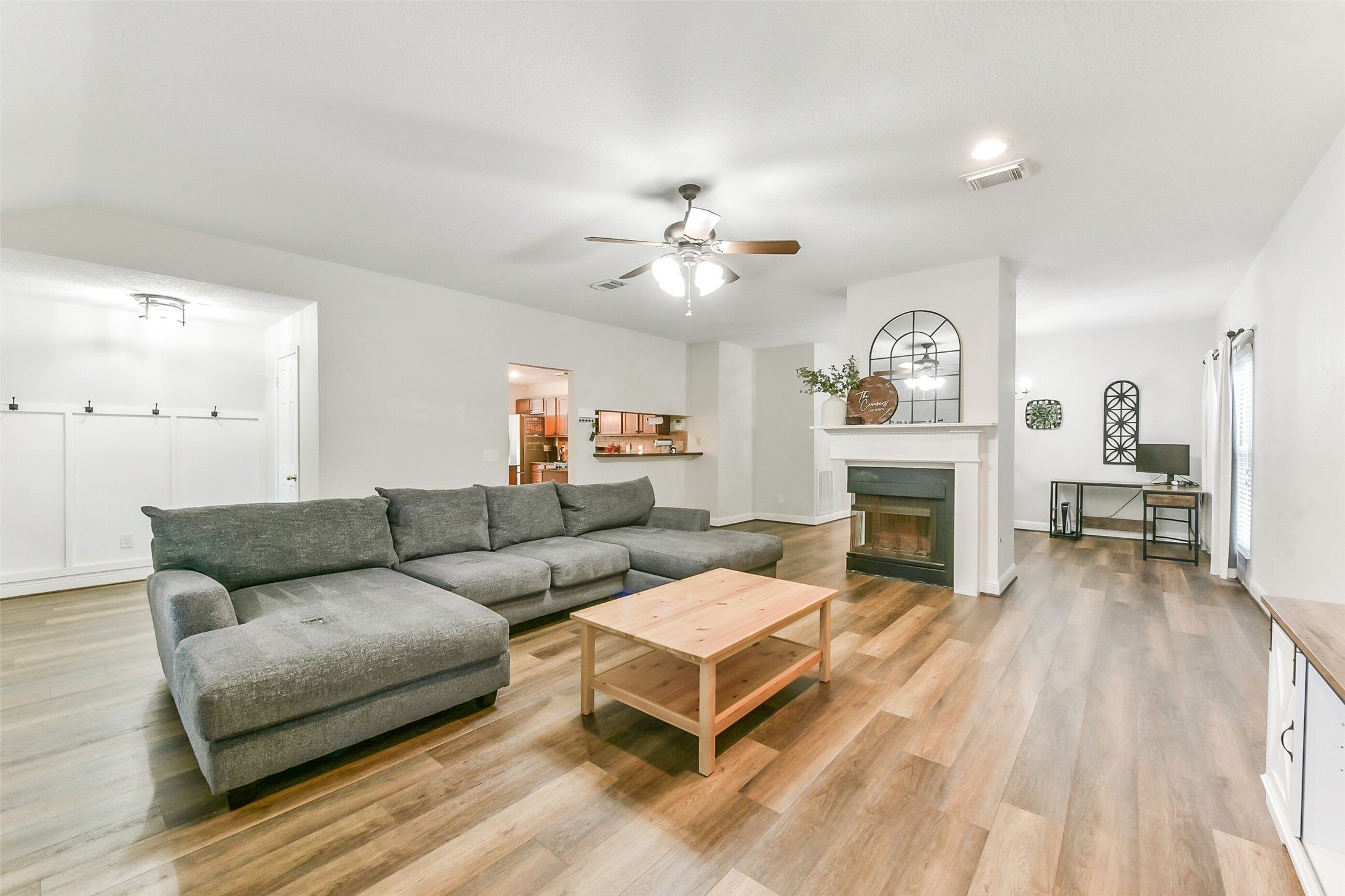 4010 Spring Branch Drive West Pearland, TX 77584 - Photo 8 of 35 a living room with furniture a fireplace and a flat screen tv
