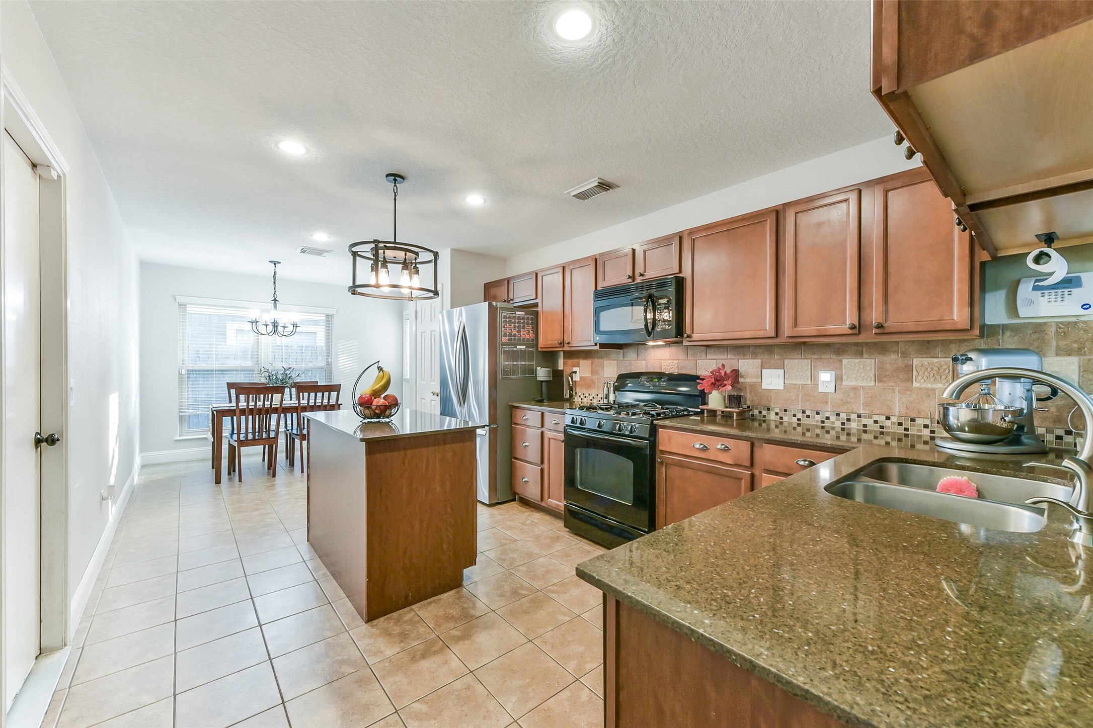 4010 Spring Branch Drive West Pearland, TX 77584 - Photo 9 of 35 a kitchen with a sink a counter top space appliances and cabinets