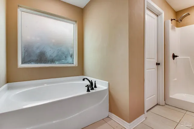 a white bath tub sitting next to a small window
