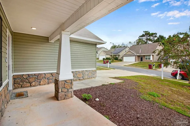 a view of a patio with table and chairs and potted plants